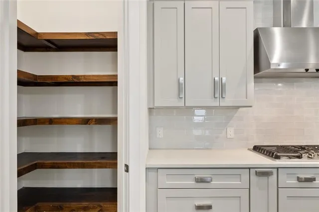 a large kitchen with stainless steel appliances granite countertop a lot of counter space and wooden floors
