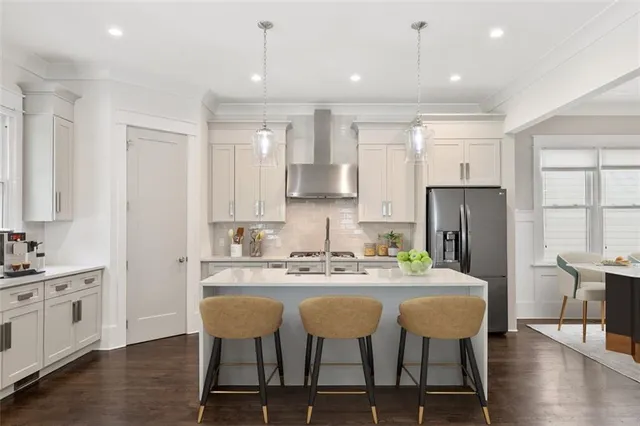 an empty room with wooden floor fireplace and windows