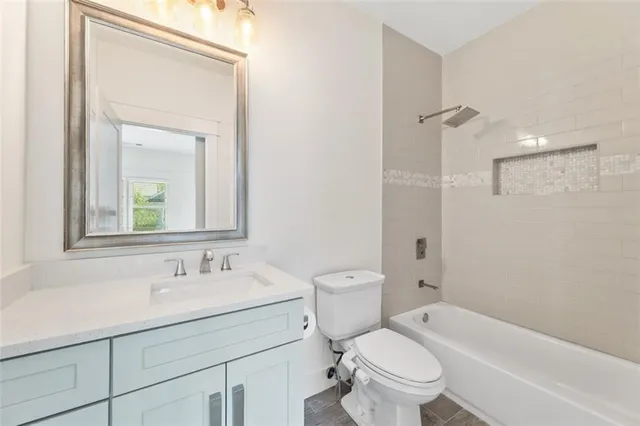 a bathroom with a sink toilet vanity and shower