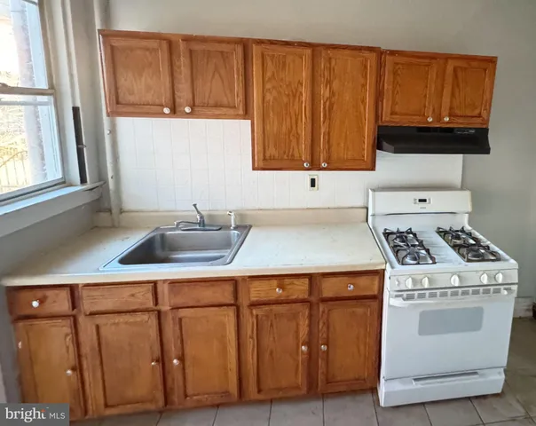 a kitchen with wooden cabinets and white appliances