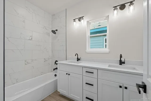 an empty room with ceiling fan and window