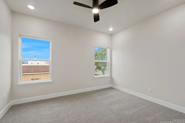 a view of room with window and wooden floor