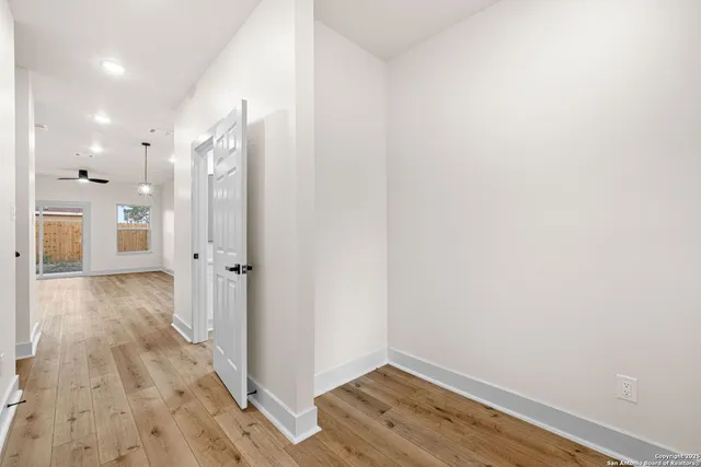 a view of a hallway with wooden floor