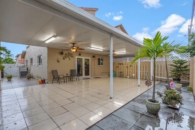 a lobby with furniture and potted plants