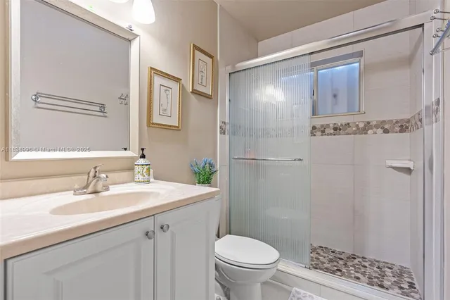 a bathroom with a sink toilet and shower