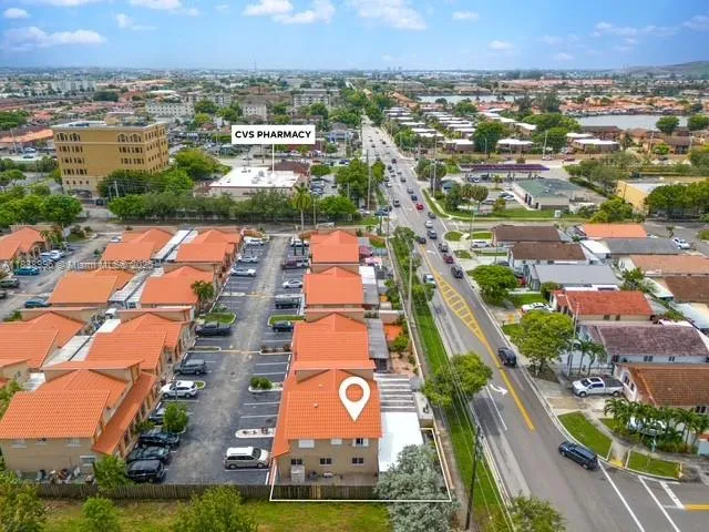 an aerial view of residential houses with outdoor space and swimming pool