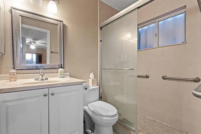 a bathroom with a toilet sink and mirror