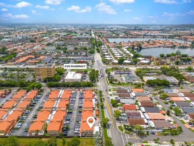 an aerial view of residential houses with yard