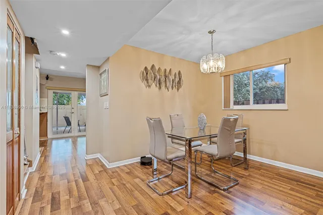 a view of a dining room with furniture wooden floor and a chandelier