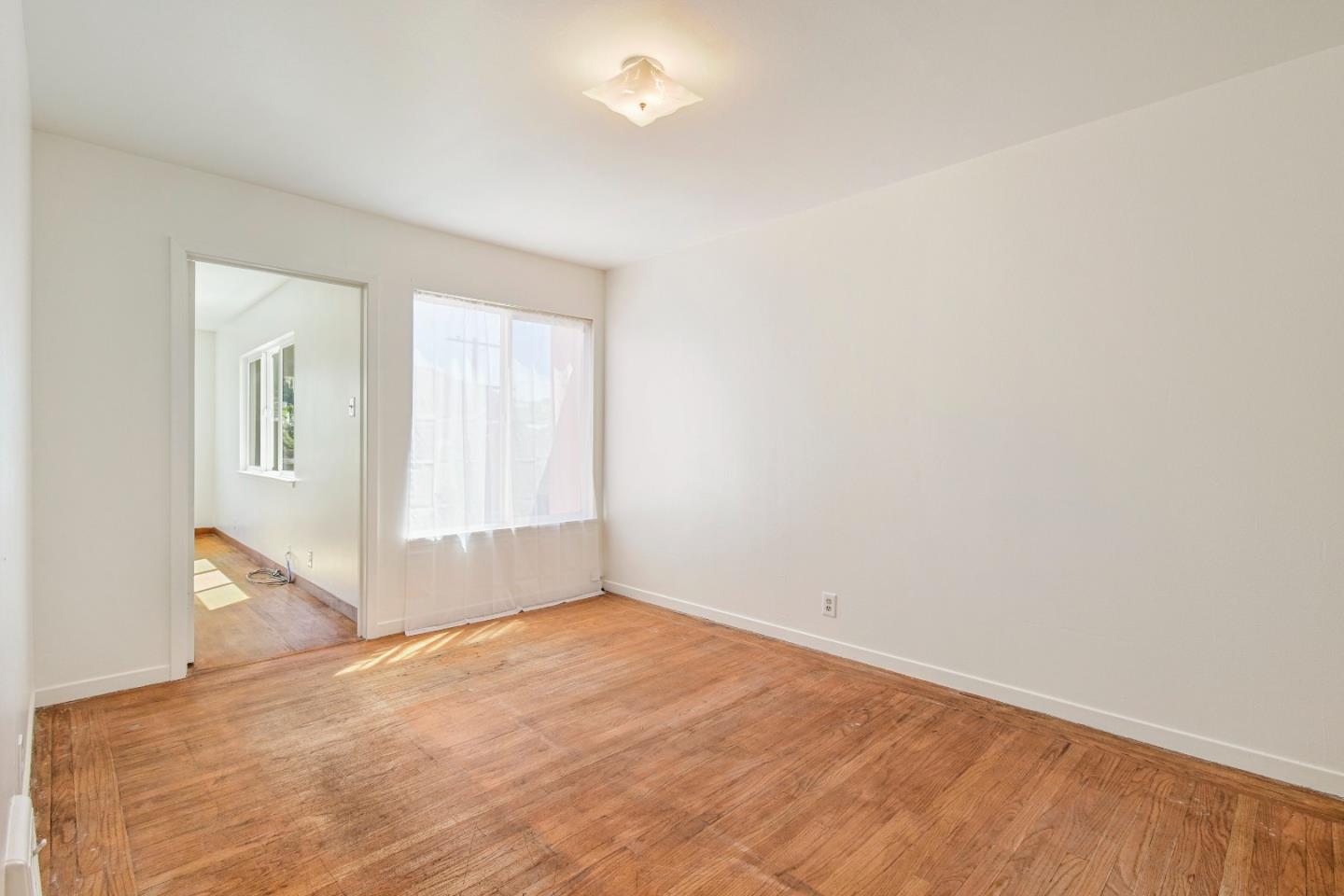 931 Hillside Boulevard Daly City, CA 94014 - Photo 24 of 63 an empty room with windows and closet