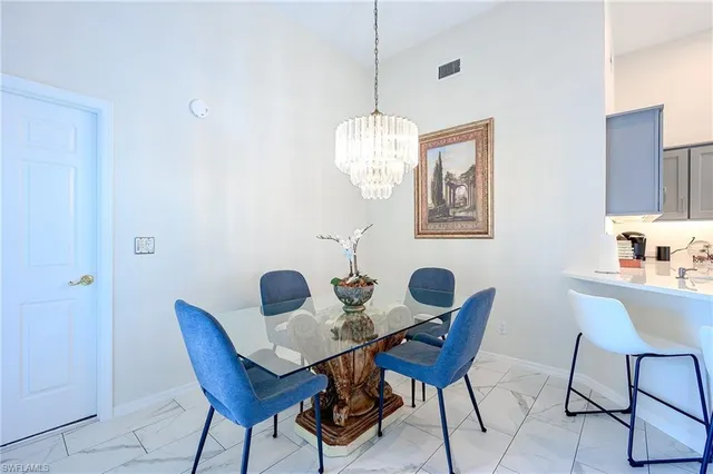 a dining room with furniture and chandelier