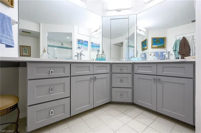 a spacious bathroom with double sink and a mirror
