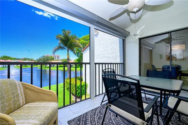 a view of a dining room with furniture wooden floor and chandelier