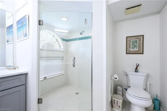a bathroom with a toilet sink and shower