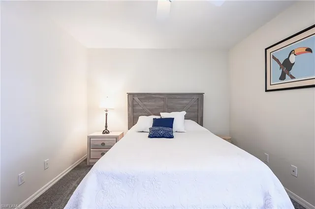 a bedroom with a bed and a night stand