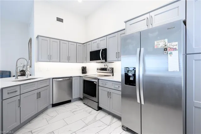 a kitchen with cabinets and stainless steel appliances