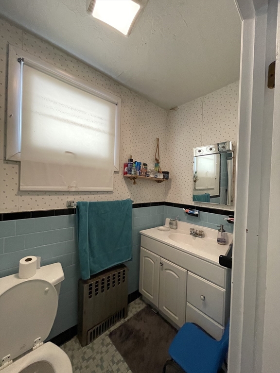 109 Wordsworth Street, Unit 2 Boston, MA 02128 - Photo 14 of 16 a bathroom with a sink toilet and mirror