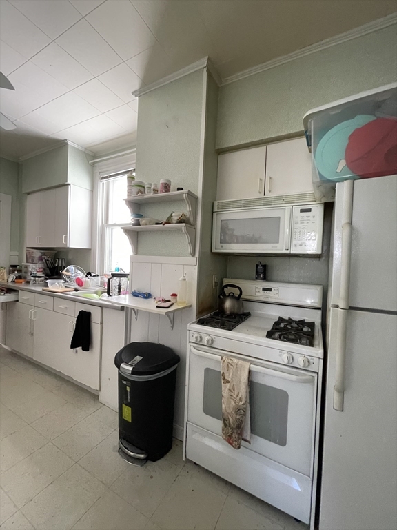 109 Wordsworth Street, Unit 2 Boston, MA 02128 - Photo 2 of 16 a kitchen with stainless steel appliances a stove a microwave and a refrigerator