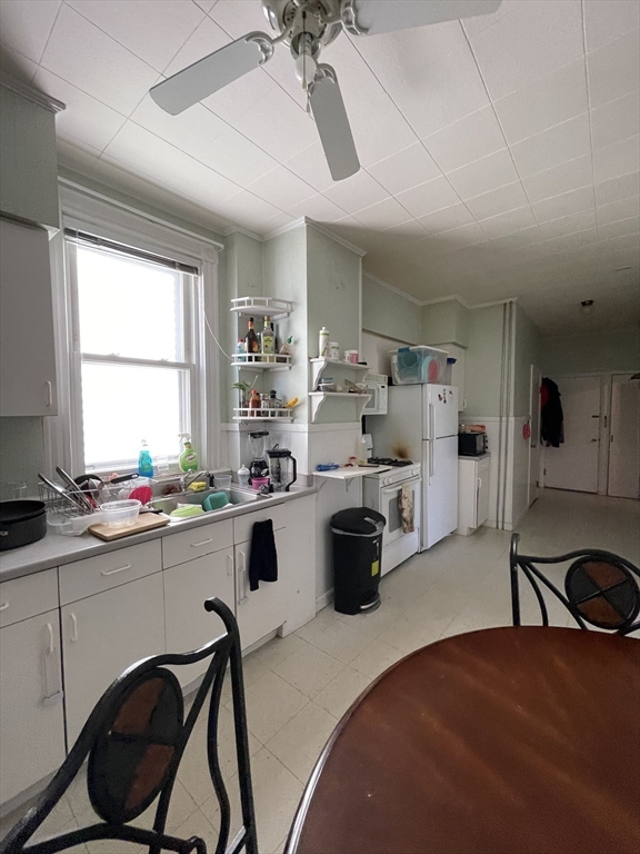 109 Wordsworth Street, Unit 2 Boston, MA 02128 - Photo 4 of 16 a kitchen with sink cabinets and window