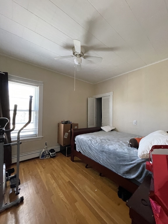 109 Wordsworth Street, Unit 2 Boston, MA 02128 - Photo 6 of 16 a bedroom with a bed and large windows