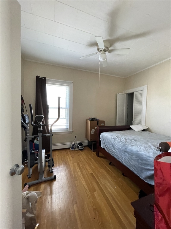 109 Wordsworth Street, Unit 2 Boston, MA 02128 - Photo 7 of 16 a bedroom with bed mirror and window