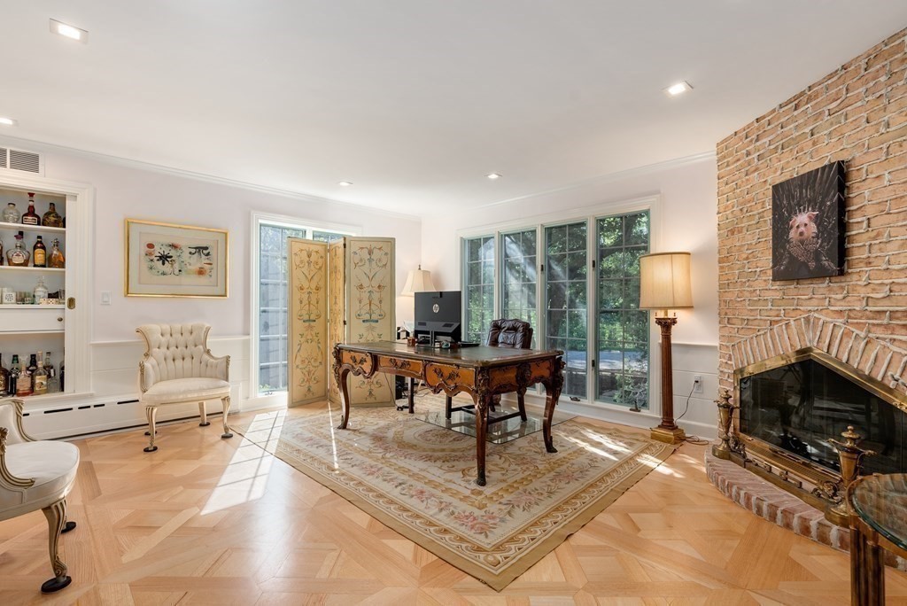 55 Scotch Pine Road Weston, MA 02493 - Photo 14 of 39 a living room with furniture a fireplace and a table