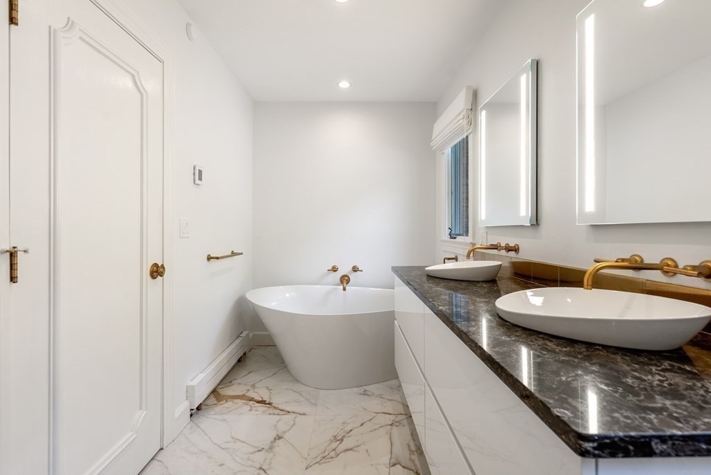 55 Scotch Pine Road Weston, MA 02493 - Photo 20 of 39 a spacious bathroom with a double vanity sink and a mirror