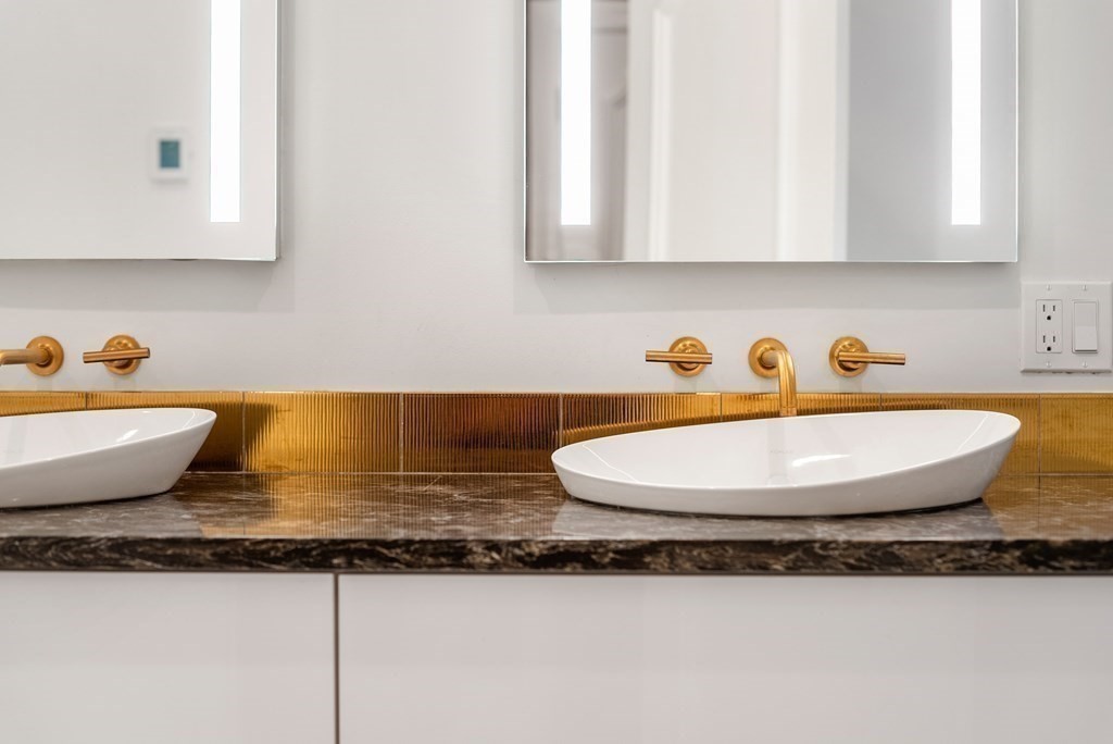 55 Scotch Pine Road Weston, MA 02493 - Photo 21 of 39 a bathroom with a granite countertop sink and a mirror