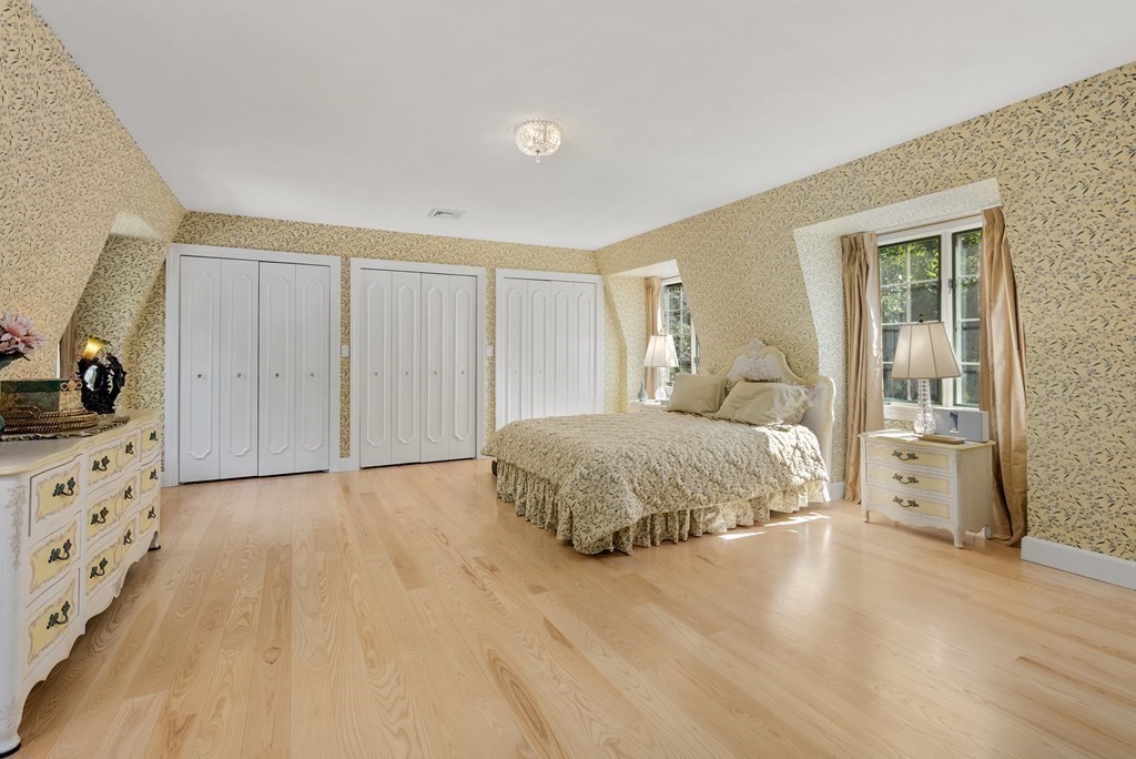 55 Scotch Pine Road Weston, MA 02493 - Photo 22 of 39 a spacious bedroom with a bed and wooden floor