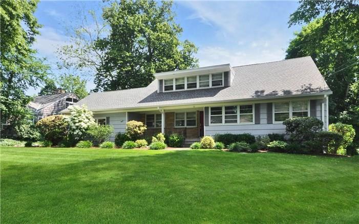 56 Westcott Road Stamford, CT 06902 - Photo 1 of 1 a front view of a house with garden and trees