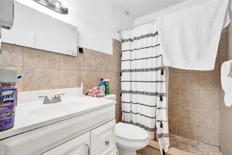 a bathroom with a sink toilet and shower