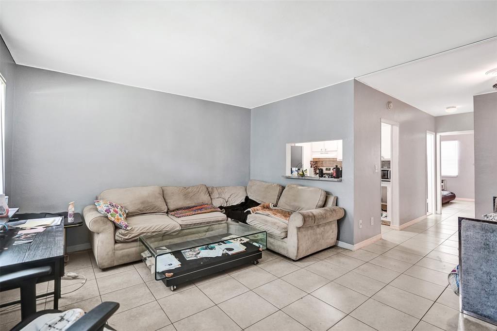 2915 Plunkett Street, Unit 5D Hollywood, FL 33020 - Photo 6 of 11 a living room with furniture and a couch