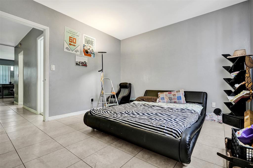 2915 Plunkett Street, Unit 5D Hollywood, FL 33020 - Photo 9 of 11 a bedroom with a bed and cabinets