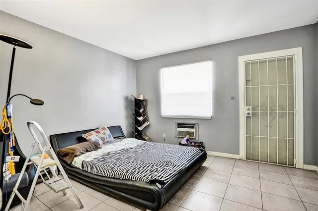 a bedroom with a bed and window