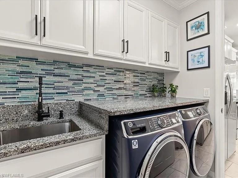 14672 Edgewater Circle Naples, FL 34114 - Photo 13 of 41 a view of kitchen sink and washer dryer