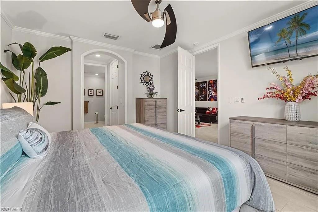 14672 Edgewater Circle Naples, FL 34114 - Photo 17 of 41 a bedroom with a bed and a potted plant