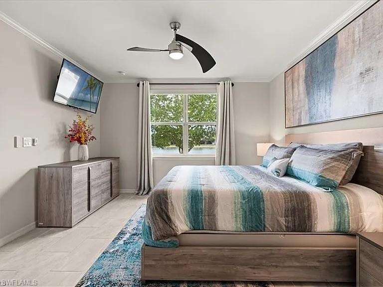 14672 Edgewater Circle Naples, FL 34114 - Photo 18 of 41 a bedroom with a large bed and a flat tv screen