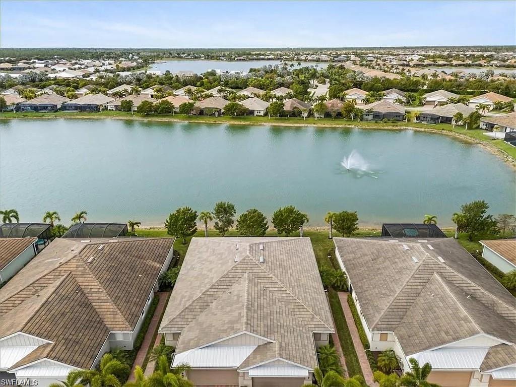 14672 Edgewater Circle Naples, FL 34114 - Photo 26 of 41 an aerial view of a house with a lake view
