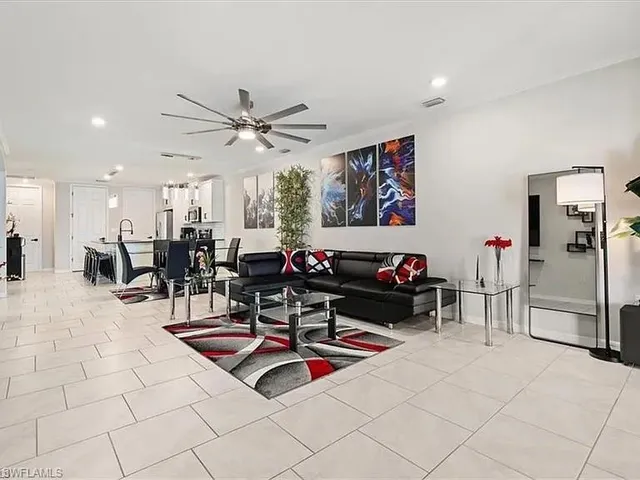 a living room with furniture a table and chairs