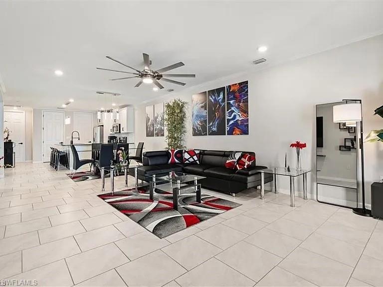 14672 Edgewater Circle Naples, FL 34114 - Photo 5 of 41 a living room with furniture a table and chairs