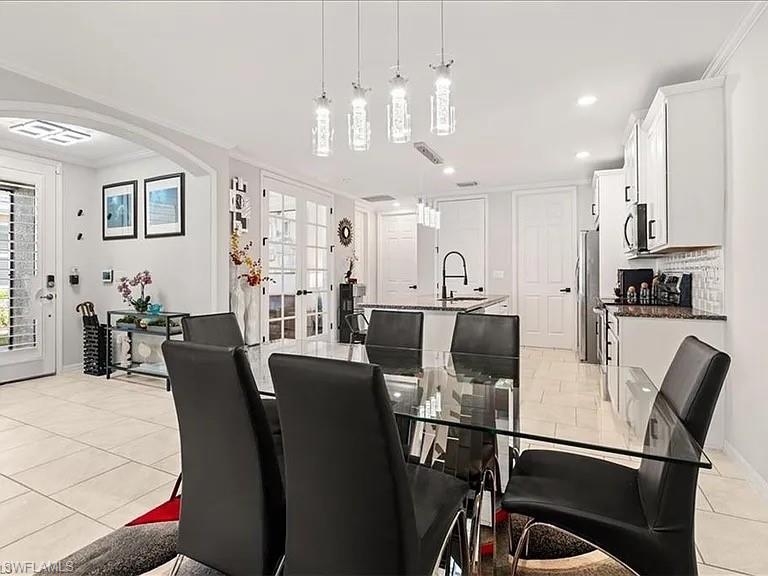 14672 Edgewater Circle Naples, FL 34114 - Photo 6 of 41 a view of a dining room with furniture and a chandelier
