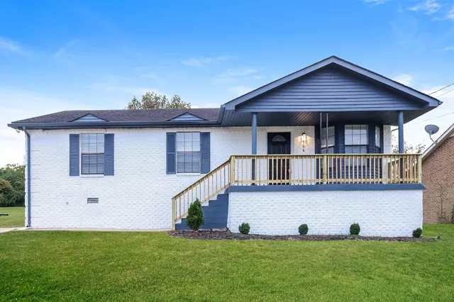 a front view of a house with a yard and porch