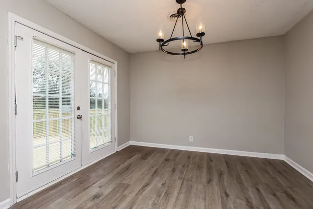 a view of a room with wooden floor and window