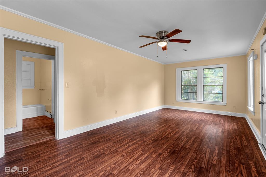 115 Pam Street Mansfield, LA 71052 - Photo 8 of 25 wooden floor in an empty room with a window