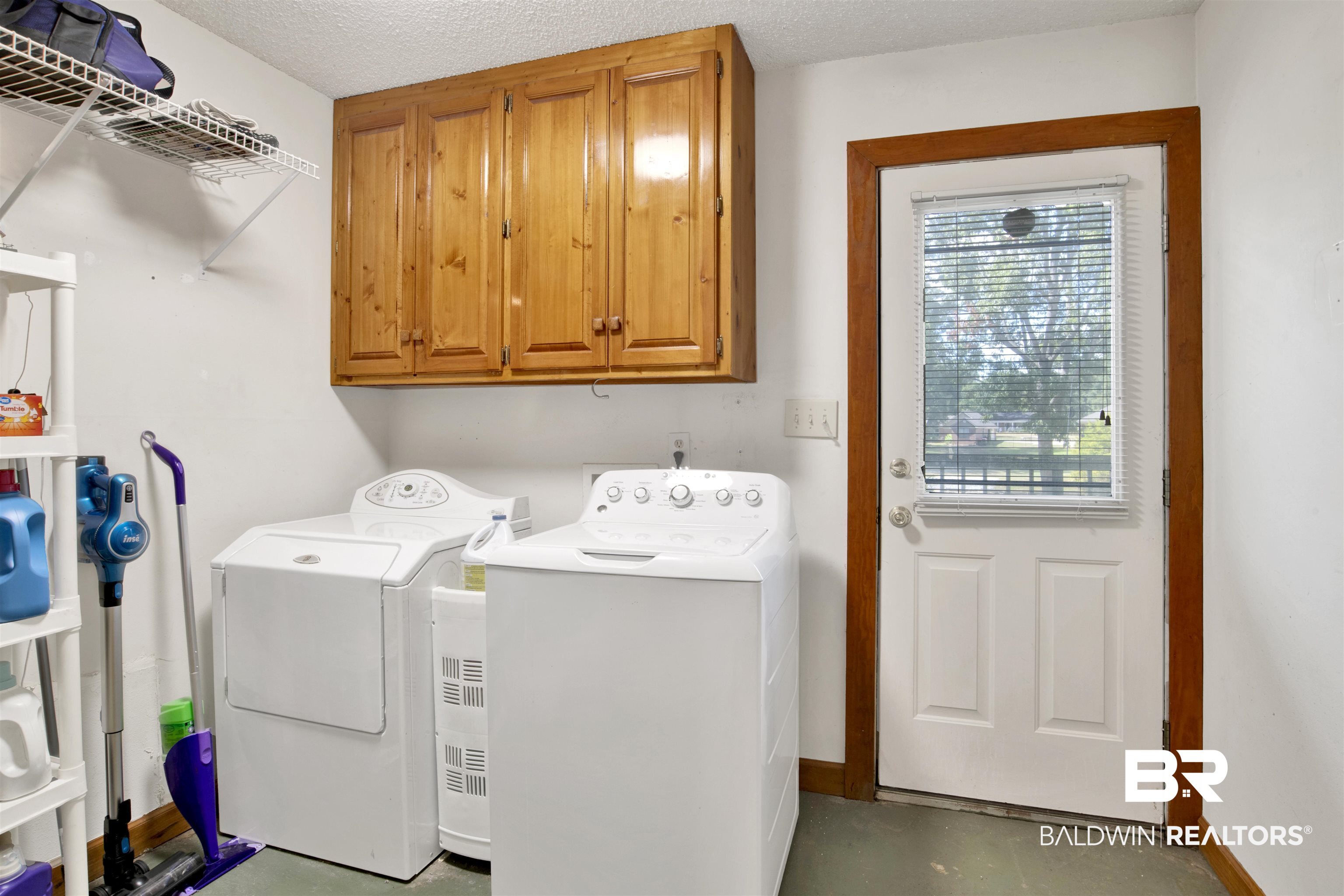 4890 Red Creek Road Semmes, AL 36575 - Photo 17 of 47 Laundry area featuring a textured ceiling, washing machine and dryer, and cabinets