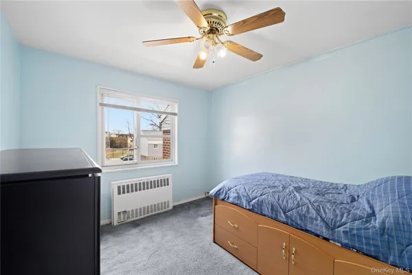 a living room with a couch and a ceiling fan