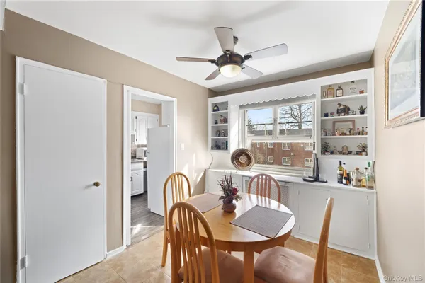a dining room with furniture a window and chandelier