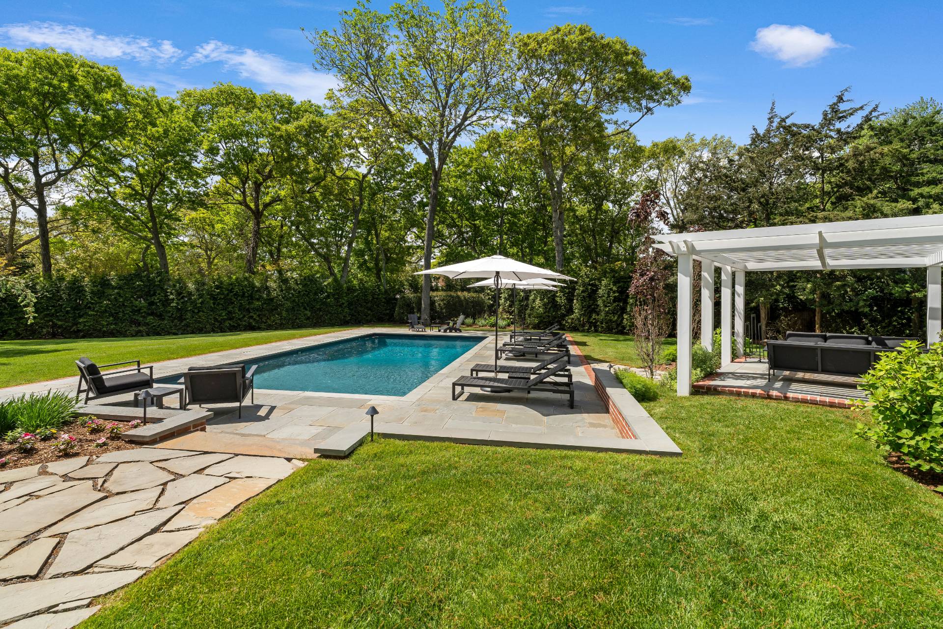 91 East Tiana Road Hampton Bays, NY 11946 - Photo 40 of 46 a view of a house with backyard sitting area and garden