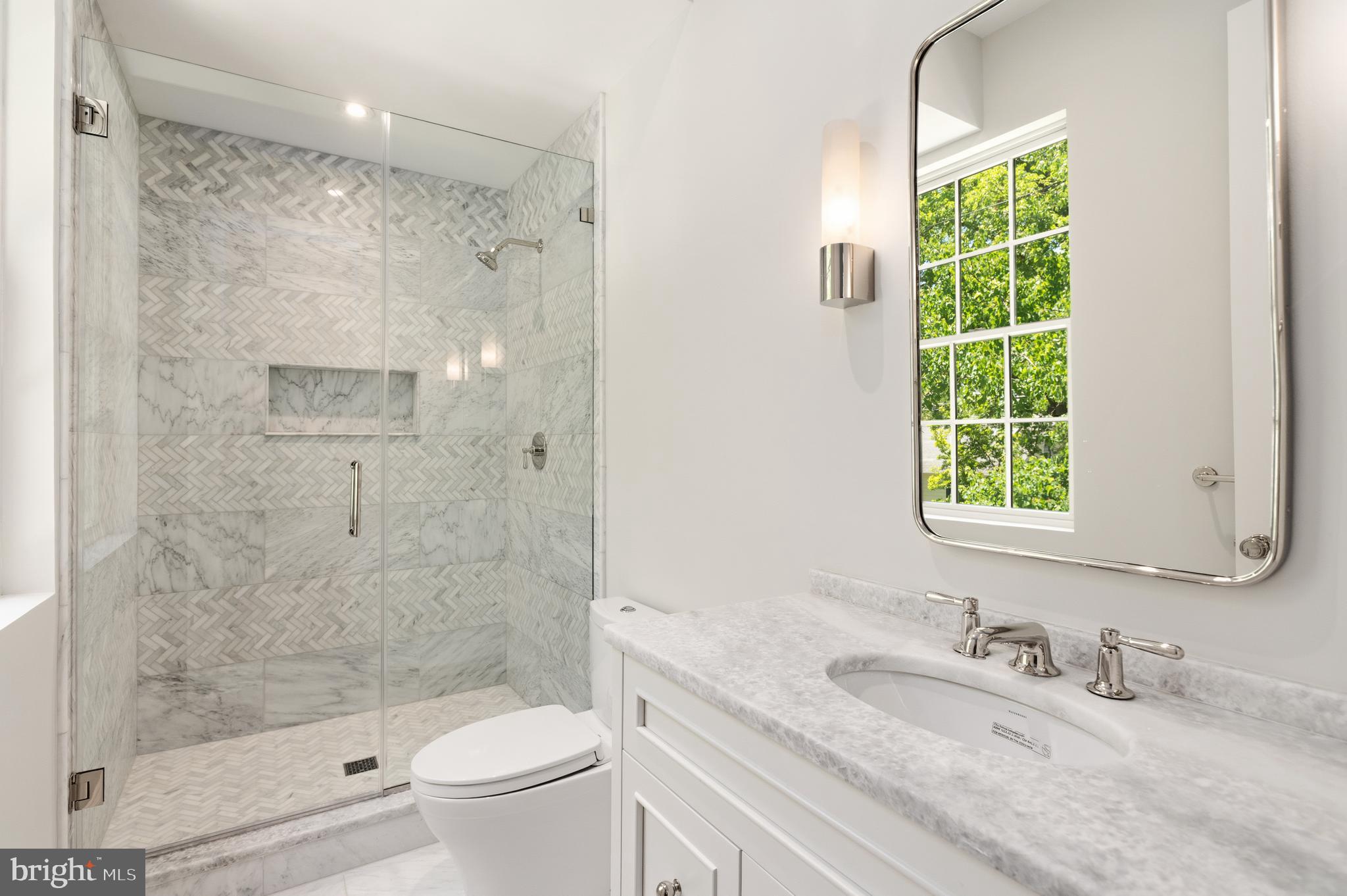 2604 36th Street Northwest Washington, DC 20007 - Photo 22 of 38 a bathroom with a granite countertop sink a toilet and shower