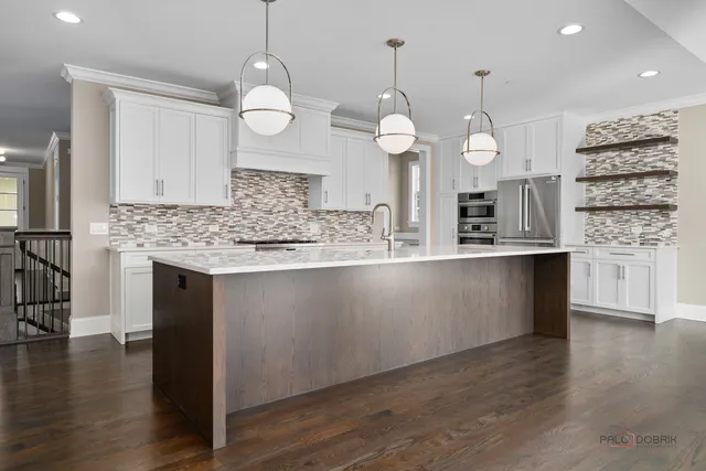 a kitchen with counter top space a sink appliances and cabinets